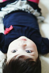 Portrait of cute boy lying at home