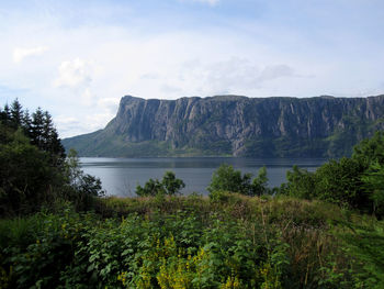 Scenic view of lake and mountains against sky