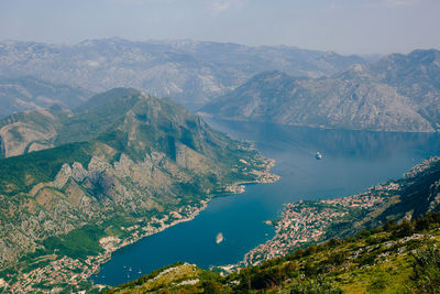 High angle view of sea and mountains against sky