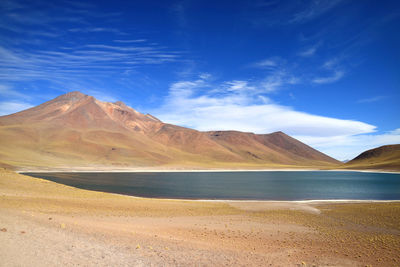 Scenic view of landscape and mountains against blue sky