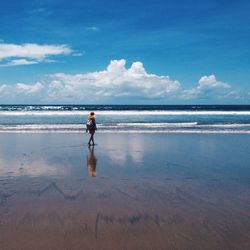 Full length of man on beach against sky