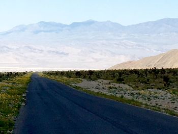 Empty road leading towards mountains