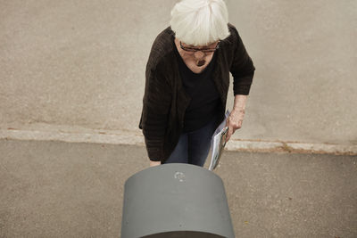 Senior woman standing near mailbox