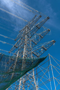 A newly installed high-voltage pylon with some cables connected