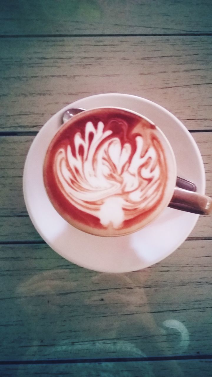 food and drink, coffee cup, drink, refreshment, table, saucer, freshness, coffee - drink, indoors, frothy drink, cappuccino, coffee, still life, spoon, froth art, cup, high angle view, directly above, wood - material, close-up