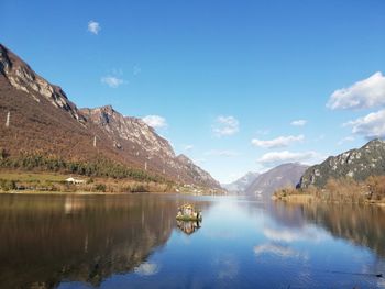 Scenic view of lake and mountains against sky