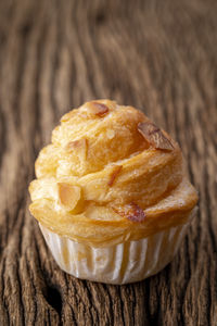 Almond cruffin with custard filling on rustic wood, cruffin is hybrid of croissant and muffin