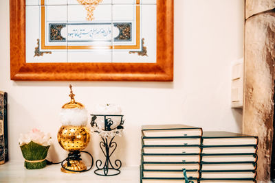 Potted plants on table against wall at home