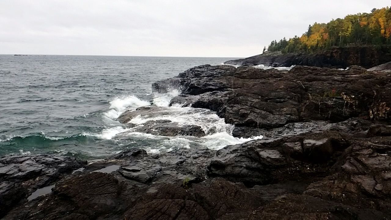 sea, water, sky, rock, beauty in nature, rock - object, scenics - nature, horizon, solid, horizon over water, motion, land, nature, rock formation, no people, wave, beach, day, tranquil scene, outdoors, power in nature, rocky coastline, breaking, hitting