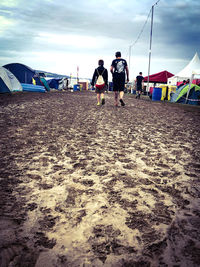 People on beach against sky