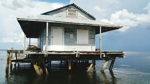 Lifeguard hut by sea against sky