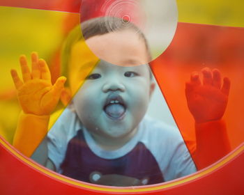 Close-up portrait of smiling boy playing