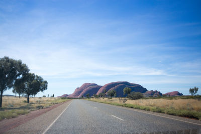Empty road along countryside landscape