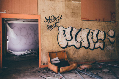 Graffiti on wall at abandoned house