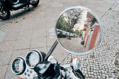 High angle view of man on side-view mirror