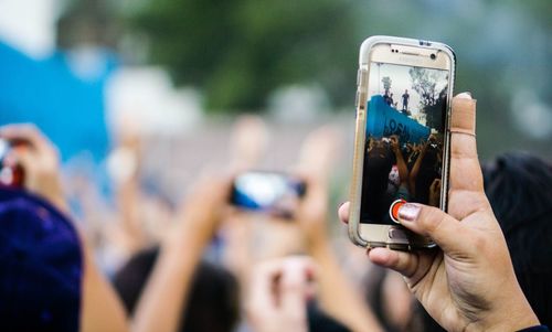 Man taking picture of a mobile phone