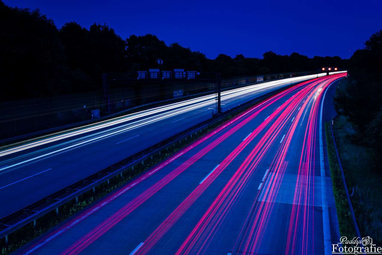 HIGH ANGLE VIEW OF LIGHT TRAILS ON HIGHWAY