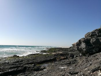 Scenic view of sea against clear blue sky