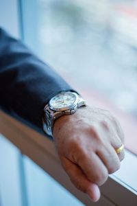 Cropped hand of man wearing wristwatch