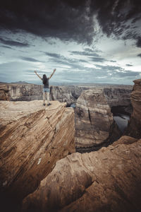 Woman in horseshoe bend point at sunset