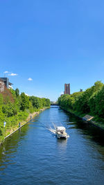 Scenic view of river against clear blue sky