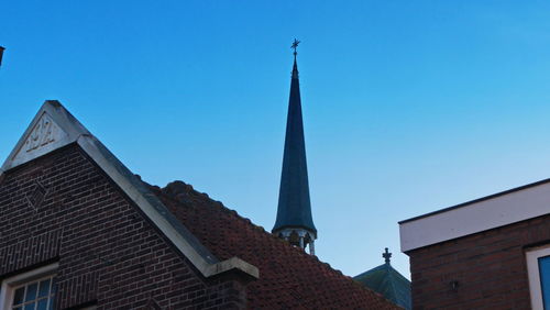 Low angle view of building against clear blue sky