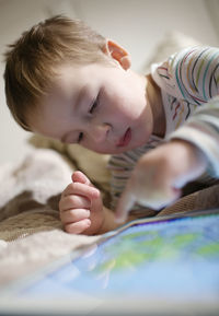 Close-up of boy on bed