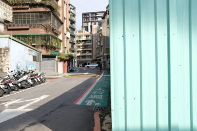 Vehicles on road along buildings