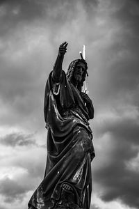 Low angle view of statue against cloudy sky