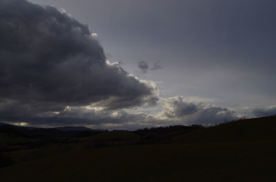 Scenic view of storm clouds over landscape