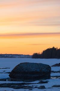 Scenic view of frozen sea against sky during sunset
