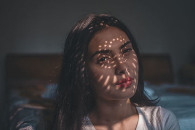 Portrait of a young woman looking away