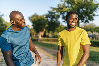 Cheerful young men enjoying at park on sunny day