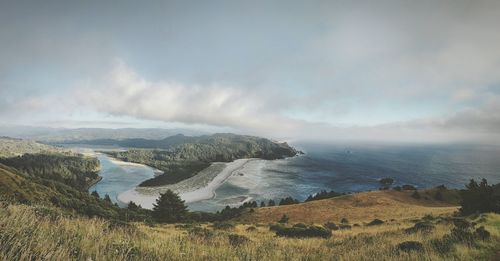 Scenic view of sea against cloudy sky