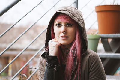 Portrait of beautiful young woman standing outdoors