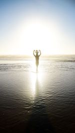 Man standing on beach against clear sky