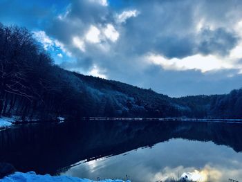 Scenic view of lake and mountains against sky