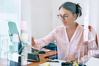 Middle-aged woman social worker check accounts bills. 