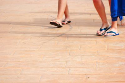 Low section of woman standing on tiled floor