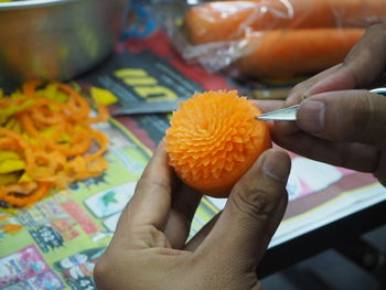 Close-up of person holding food on table