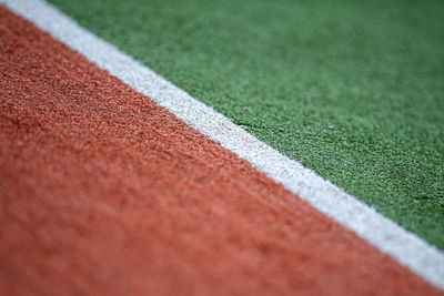 Close-up of road passing through green grass