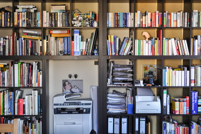 Books arranged in bookshelf at library
