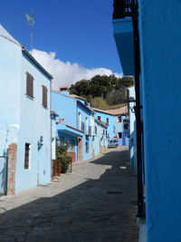 Empty alley amidst buildings in city