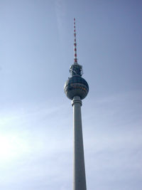 Low angle view of communications tower against sky