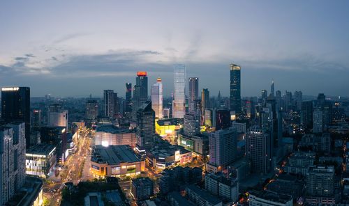 High angle view of illuminated buildings in city against sky