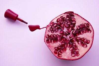 Close-up of red fruit over white background