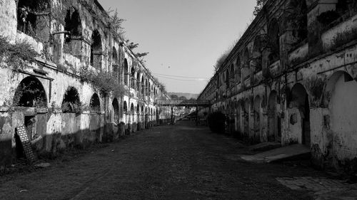 Footpath amidst buildings against sky