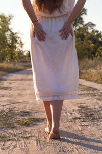 Close up woman in linen dress strolling at leisurely pace concept photo