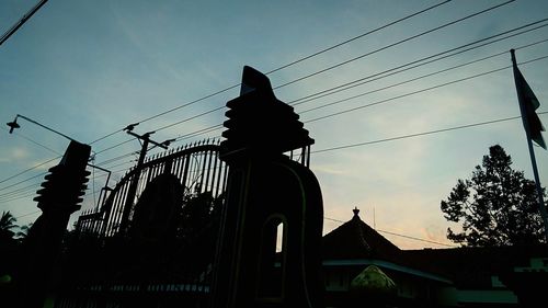 Low angle view of silhouette building against sky at sunset