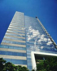 Low angle view of modern building against blue sky